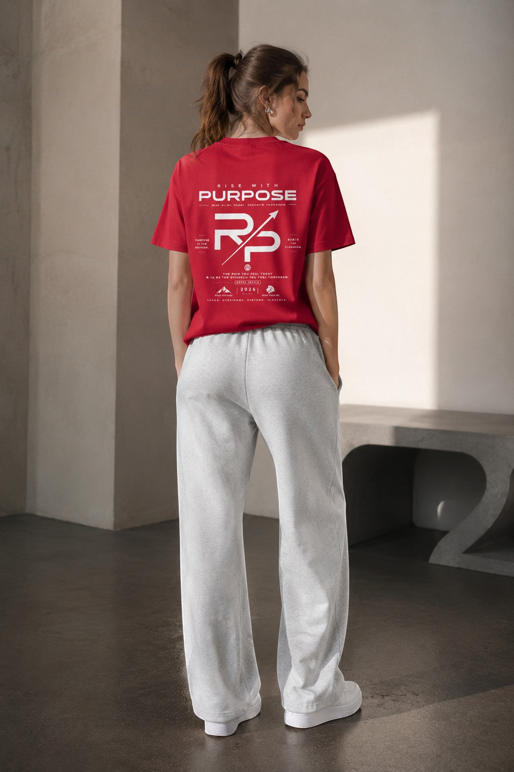 Rise With Purpose red Sorona quick-dry cooling t-shirt with graphic print on back, worn by a woman.